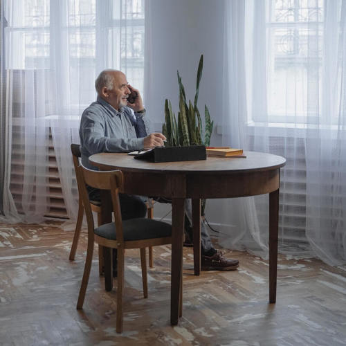 Man sat alone at table on Call to Spammers