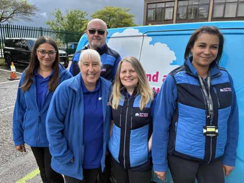 A photograph of five members of the Nottingham on Call team stood in front of a Nottingham on Call van, smiling to the camera